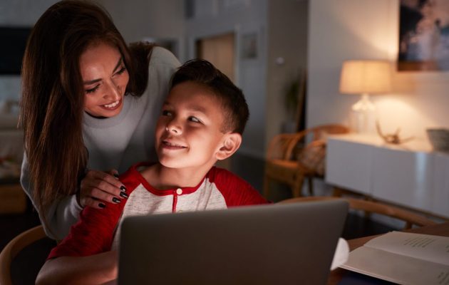Hispanic Woman Looking Over Her Sons Shoulder