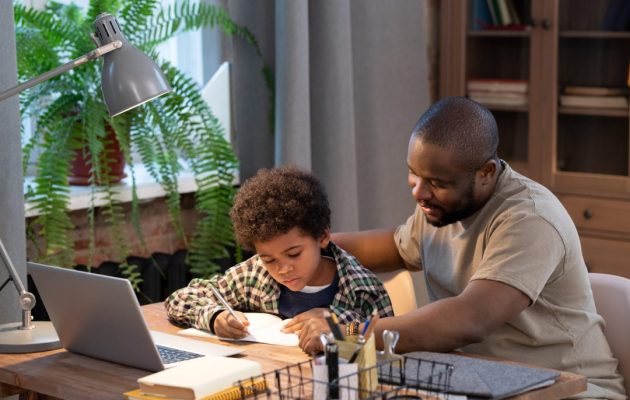 Diligent,African,Schoolboy,In,Casualwear,Looking,At,His,Notes,In