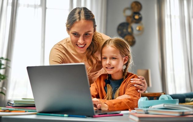 Online,Training,For,Children.,Interested,Parent,Looking,Over,Daughter's,Shoulder