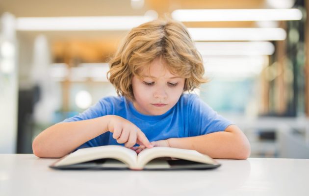 Kid,Reading,Book.,Child,Reading,Book,In,A,Public,Library. Kid,Reading,Book.,Child,Reading,Book,In,A,Public,Library.